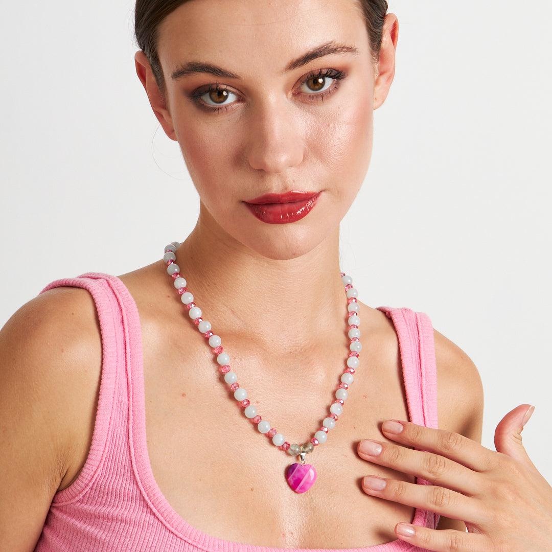 A handcrafted necklace featuring a pink heart pendant with white and pink beaded chain, perfect for adding a touch of elegance to any outfit