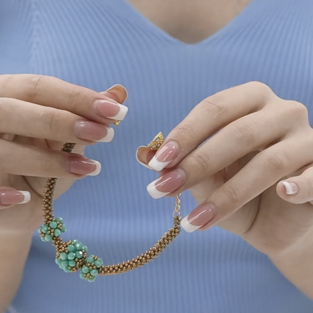 Handmade beaded wristband with a unique flower design, featuring turquoise and gold tones. The video shows the wristband's 360-degree view, highlighting the intricate beadwork, adjustable clasp, and artisan craftsmanship